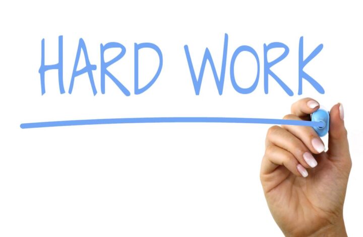 The words "hard work" are spelled out with a marker.